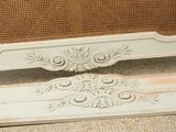 a white bed with a wooden head board on it