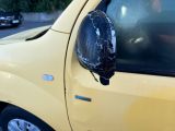 a car that has a broken mirror on the side of it