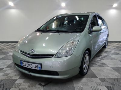 a green toyota prius parked in a room