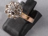 a close up of a gold ring with a flower design on it