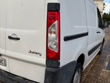 a white van that is parked on the side of the road