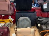 a lot of purses on a table in a store