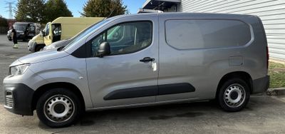 a silver van that is parked in a parking lot