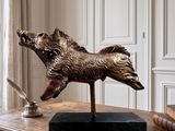 a statue of a dog on a table with a pen and inkwell