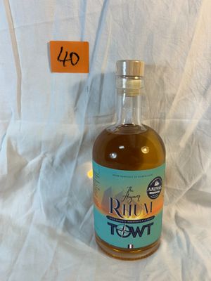a bottle of liquor sitting on a white sheet