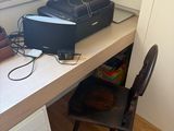 a desk with a computer and a printer on it