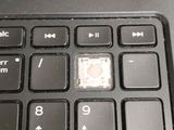 a close up of a computer keyboard with a button on it
