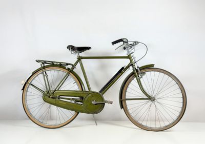 a green bicycle that is parked on a white surface