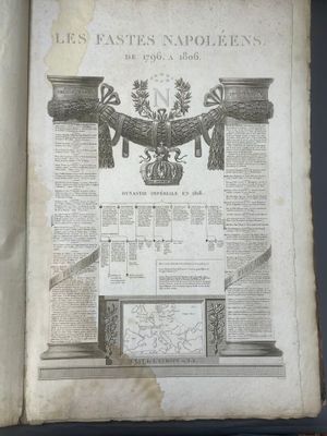 an old book with a picture of a coat of arms and a crown on it