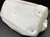 a white purse sitting on top of a black table