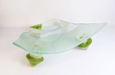 a glass bowl that is sitting on top of a table