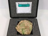 an open case with a piece of paper and a pen in it