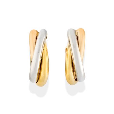 a pair of gold and silver earrings on a white background