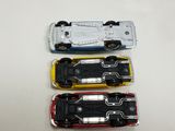 three toy cars sitting on a table next to each other