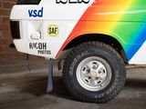 a white truck with a rainbow painted on the side of it