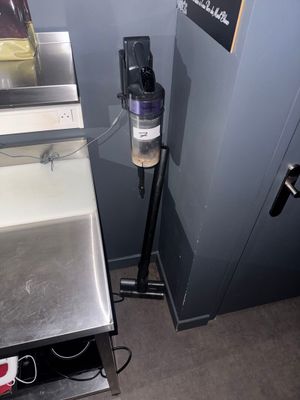 an image of a kitchen area with a sink and a coffee maker