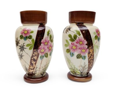 two vases with flowers painted on them on a white surface