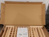 a cardboard box with a wooden bed frame inside of it