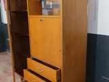 a wooden cabinet with two drawers and a glass door