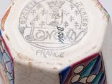 a close up of a small vase with a design on it