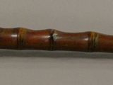 a wooden stick with a metal handle on it