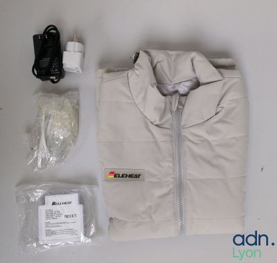 a white jacket and other items laid out on a table