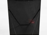 laptop computer sitting on top of a white surface with a black cover