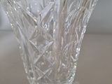 a glass vase that has a flower inside of it