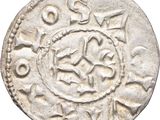 a close up of a silver coin with a design on it