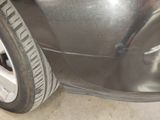 a close up of a car ' s front bumper and tire