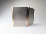 a silver and gold case sitting on top of a white table