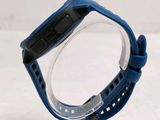 the back of a watch with a blue band on a clear case