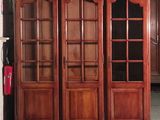 a large wooden cabinet with glass doors in a room