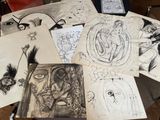 a lot of drawings on a table with a chair
