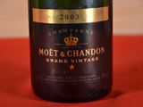 a bottle of champagne on a red table cloth