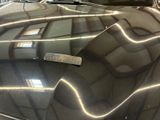 a reflection of a building on the hood of a car