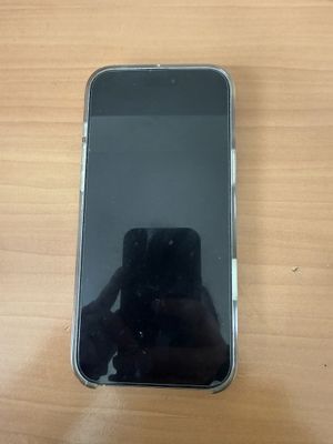 Gros plan sur un téléphone portable posé sur une table, avec une personne en train de prendre une photo