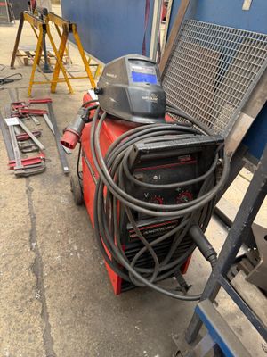 a machine that is sitting on the ground next to some tools