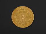 a close up of a gold coin on a black surface