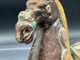 a statue of a horse that is sitting on a table