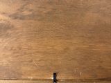 a person holding a piece of wood in their hand