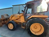 a tractor that is parked in front of a building