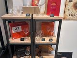 a shelf with wine glasses and wine bottles on it