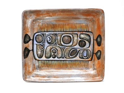 a plate with a decorative design on it on a white surface