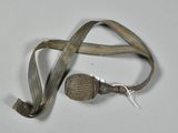 a small metal object with a cord attached to it