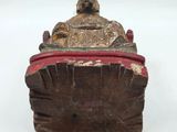 an image of a statue of a man sitting on top of a wooden box