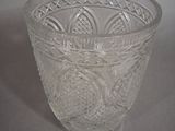 a glass cup with a pattern on it