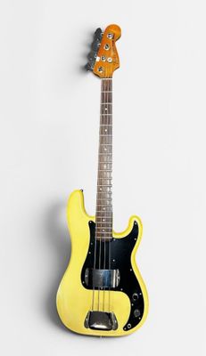 yellow electric bass guitar on white background with copy space for text