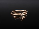 a close up of a gold ring on a black surface