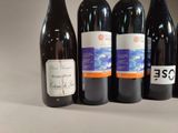 several bottles of wine are lined up on a table